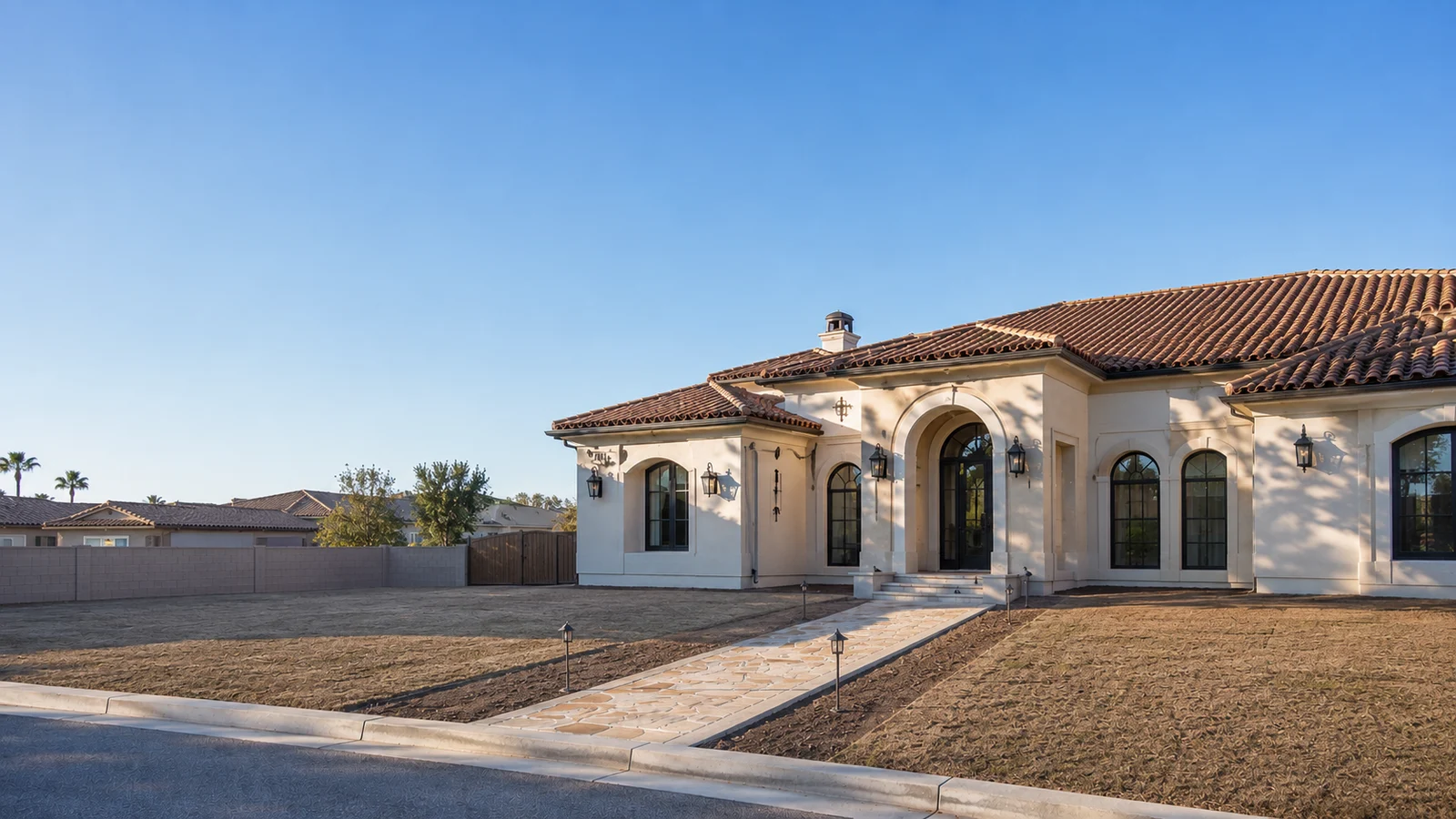 The same home before landscaping, a bare dirt yard with no plants